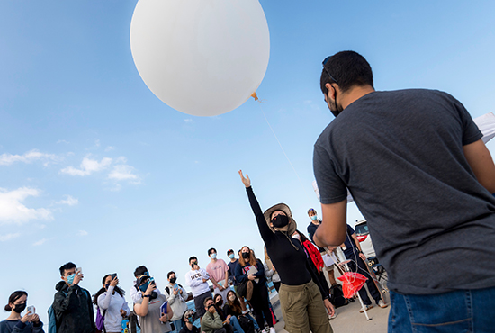 students using a weather balloon in a class setting